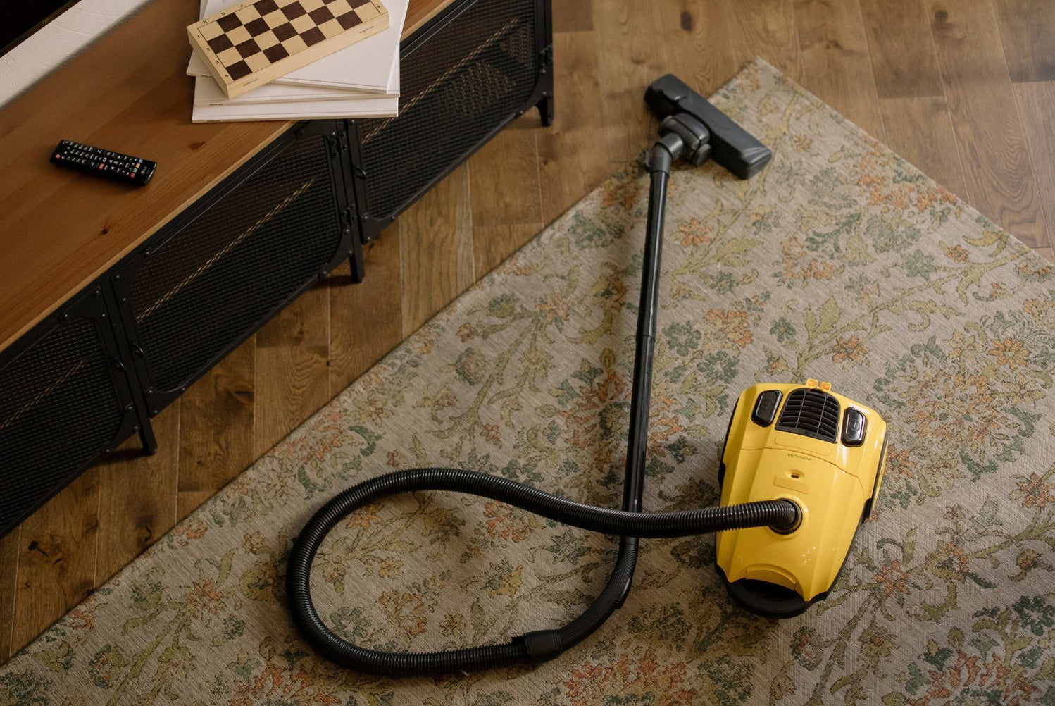 Vacuuming a Moroccan wool rug with suction only, in the direction of the pile